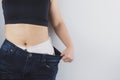 Close up shot of woman with slim body showing her diet results. Healthy nutrition, diet and weight losing concept Royalty Free Stock Photo