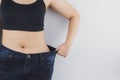 Close up shot of woman with slim body showing her diet results. Healthy nutrition, diet and weight losing concept Royalty Free Stock Photo