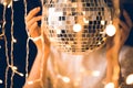 close-up shot of woman touching disco ball with beautiful Royalty Free Stock Photo