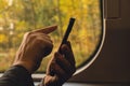 Close-up shot of woman& x27;s hands tapping on mobile phone screen. Girl in plaid shirt using modern smart phone Royalty Free Stock Photo