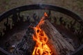 A Close up shot of wood burning in an outdoor fire pit with flames Royalty Free Stock Photo