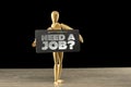 Wooden mannequin holding a need a job sign Royalty Free Stock Photo