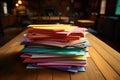 close up shot of a wooden table with different colored pile of papers