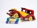 Close up shot of a wooden vintage car toy on money notes shot against white background Royalty Free Stock Photo