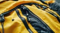 A close-up shot of a yellow backpack's zipper, featuring several water droplets on the surface of the fabric Royalty Free Stock Photo