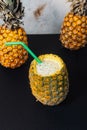 Close-up shot of a yellow pineapple with a tropical cocktail inside Royalty Free Stock Photo