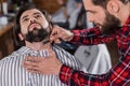 close-up shot of young barber shaving man Royalty Free Stock Photo