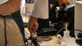 Close-up shot of young beautiful baretta making coffee with modern coffee machine. Royalty Free Stock Photo