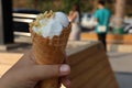 Close-up shot of a young girl& x27;s hand holding a vanilla ice cream cone. Royalty Free Stock Photo