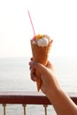 Close-up shot of a young girl& x27;s hand holding a vanilla ice cream cone. Royalty Free Stock Photo