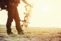 Close up shot of a hunter dressed in camouflage clothing holding a modern bow. Royalty Free Stock Photo