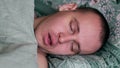 Close-up shot of young man in bed at home sleeping Royalty Free Stock Photo