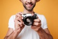 Close up shot of young man taking photo with retro camera Royalty Free Stock Photo