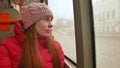 Close-up shot of a young sad woman traveling by bus on a dull rainy day. She looking out the wet window and breathing Royalty Free Stock Photo