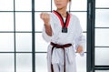 Close up shot of young taekwondo student shows different postures in front of white pattern background