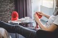 Close up shot of young woman hands knitting a red scarf handicraft in the living room on terrace at home Royalty Free Stock Photo