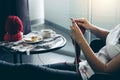 Close up shot of young woman hands knitting a red scarf handicraft in the living room on terrace at home Royalty Free Stock Photo