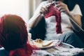 Close up shot of young woman hands knitting a red scarf handicraft in the living room on terrace at home Royalty Free Stock Photo