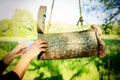 Close-up shot of a young woman putting a letter in a handmade wooden mailbox hanging from a tree Royalty Free Stock Photo