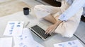 Close-up shot of young woman`s hand pressing on laptop keyboard Royalty Free Stock Photo