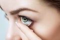 Close-up shot of young woman wearing contact lens. Royalty Free Stock Photo