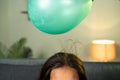 close up shoto of kids playing by placing balloon to attracting hair - conept of static cling home science experiment Royalty Free Stock Photo