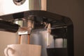 Close-up shots of Espresso machine making fresh coffee in white cup. small device for home made Royalty Free Stock Photo