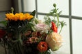 Close-up shots of various ornamental flowers by the window..