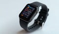 Black smartwatch on white surface displaying data screen Royalty Free Stock Photo
