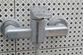 Close-up of the shower faucet with lime scale, white chalk sediment and stains. Dirty calcified shower mixer tap, faucet with Royalty Free Stock Photo