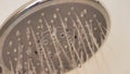 Close up Shower head with Water Drops Splashing out and Running from Faucet in Bathroom Flowing in Slow Motion shot Royalty Free Stock Photo