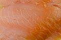 Close-up showing the texture of a slice of smoked salmon.