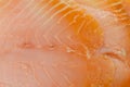 Close-up showing the texture of a slice of smoked salmon.