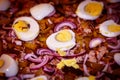 Close-up shows the ingredients for homemade pizza: pickles, minced meat, onion, boiled egg Royalty Free Stock Photo
