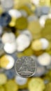 A close-up shows one 10-cent coin. This is money. Blurred money background. Dime, the smallest 0.10 Canadian dollar coin. The