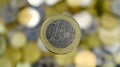 A close-up shows one 1 euro coin. This is money. Blurred money background. On the reverse side there is an expanded map of the EU Royalty Free Stock Photo