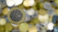 A close-up shows one 1 euro coin. This is money. Blurred money background. On the reverse side there is an expanded map of the EU Royalty Free Stock Photo