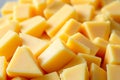 A close-up shows yellow cheddar cheese cubes, creating a dense, textured background Royalty Free Stock Photo