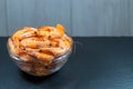 Close-up of shrimp in a glass bowl on a dark stone background. Seafood, healthy food concept. Place for your text. Royalty Free Stock Photo