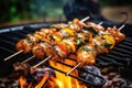close-up of shrimp skewers sizzling on campfire grill