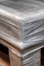 Close-Up of Shrink-Wrapped Pallet Corner with Tensioned Plastic Texture Royalty Free Stock Photo