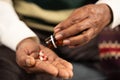 Close up of sick elder man hands taking tablets or pills