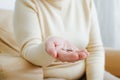 Close-up of sick senior woman's hand holding two capsules of pharmaceutical medicine, painkiller, vitamins. Royalty Free Stock Photo