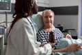 Close up of sick unwell senior man patient laying in hospital bed