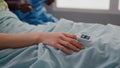 Close up of sick woman resting in bed in hospital ward Royalty Free Stock Photo