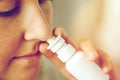 Close up of sick woman using nasal spray Royalty Free Stock Photo