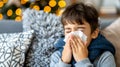 Close up of sick young boy blowing his nose into a tissue, concept of illness and healthcare Royalty Free Stock Photo