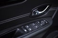 Close-up of the side door buttons: window adjustment buttons, door lock. modern car interior: parts, buttons, knobs Royalty Free Stock Photo