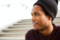 Close up side of handsome young african american man smiling with beanie and looking away Royalty Free Stock Photo