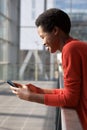 Close up side of happy young african american woman looking at cellphone Royalty Free Stock Photo